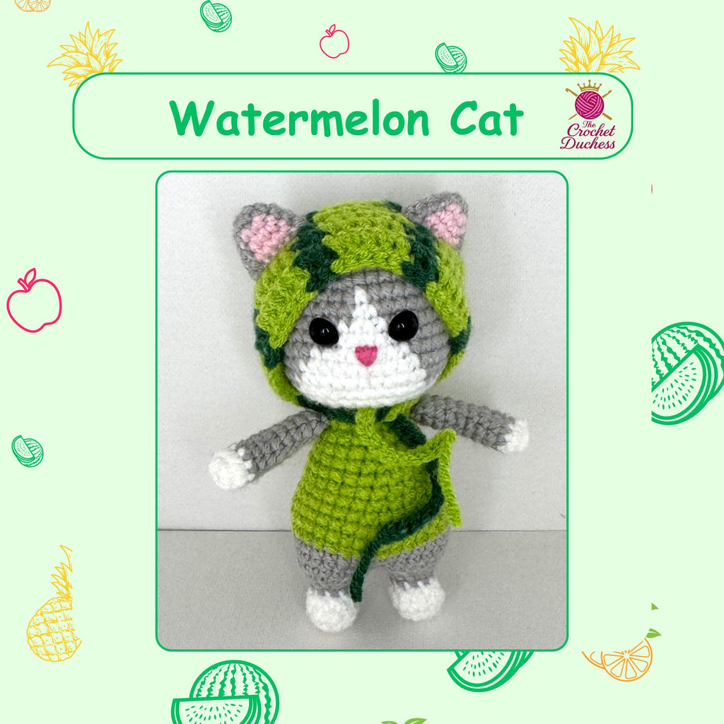 A crocheted amigurumi cat doll wearing a green watermelon-patterned hood and dress, with pink inner ears, black eyes, and a small pink heart on its face. The image is framed with a green border and watermelon-themed illustrations, with the text 'Watermelon Cat' and a 'The Crochet Duchess' logo.